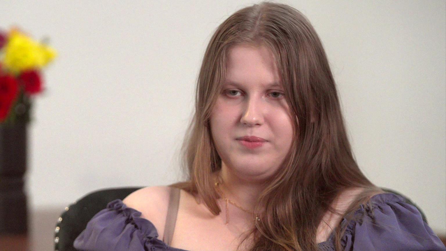 Julia Wandelt has long dark hair and wears a purple top.
