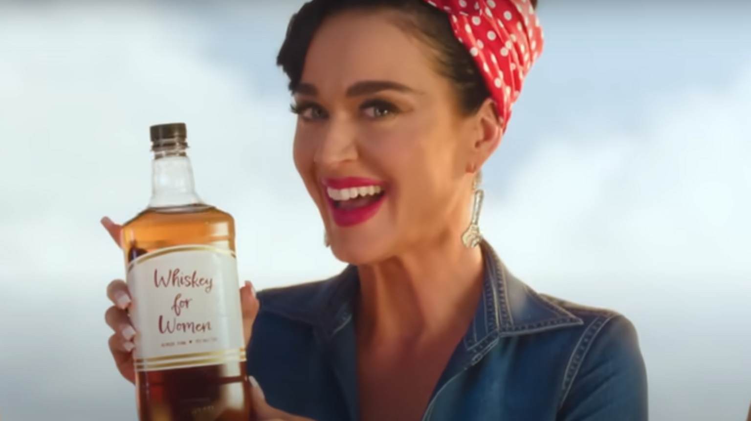 Katy Perry in the Woman's World video dressed as Rosie the Riveter, drinking 'Whiskey for Women'