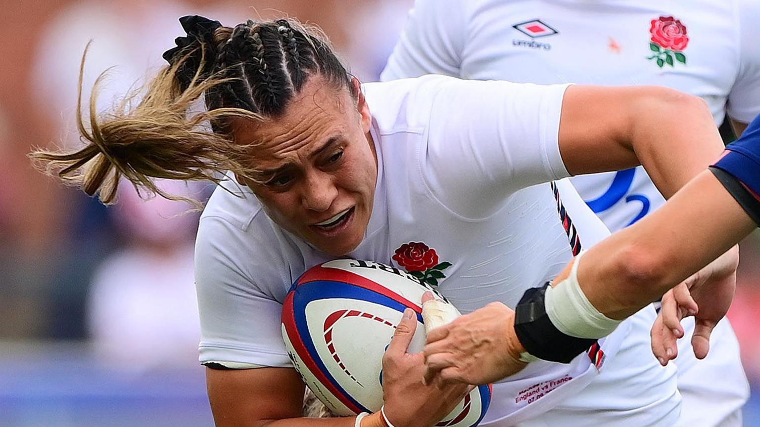 Maddie Feaunati drives the ball forward for England