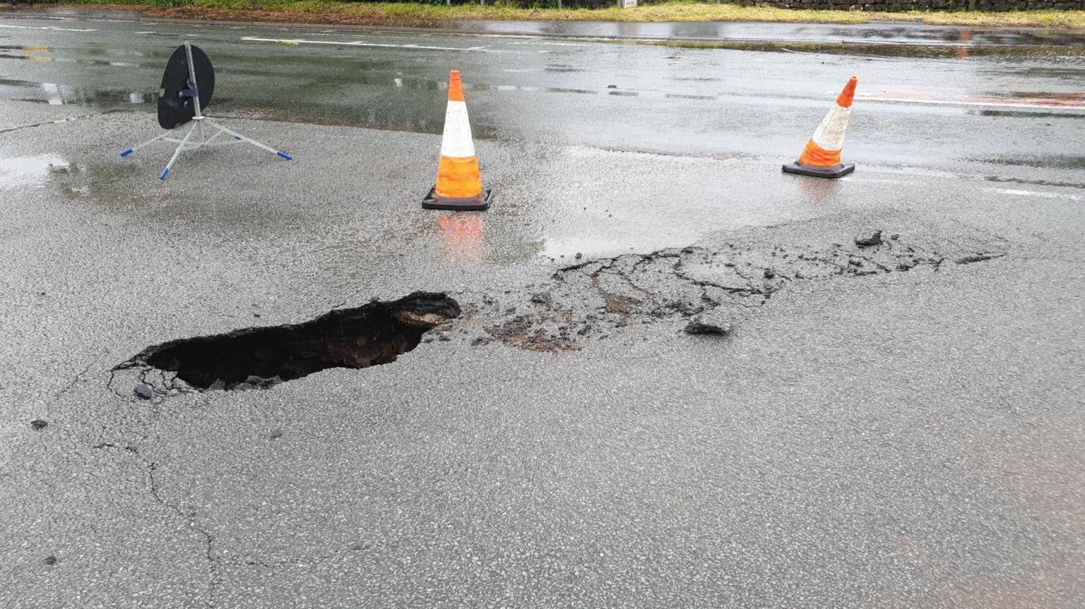 The road with a hole in it before it collapsed