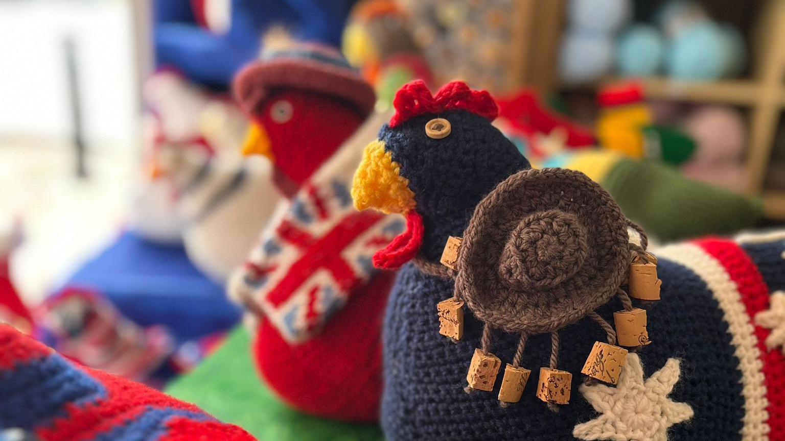 A picture of some of the knitted hens previously on display. They represent several different nations and there flags.