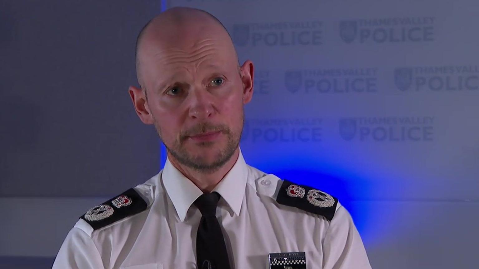 Chief Police Constable Jason Hogg is in a shirt and tie in front of a wall with the Thames Valley Police logo on.