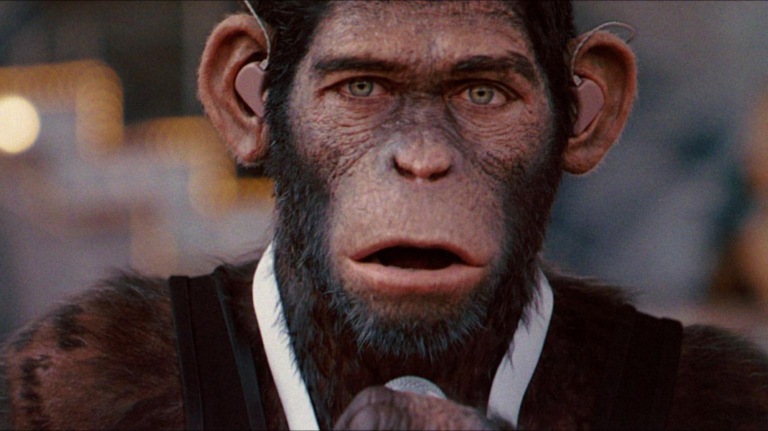 A close up of the chimpanzee Robbie Williams in Better Man wearing a white tie like the singer did during his shows at Knebworth 2003.