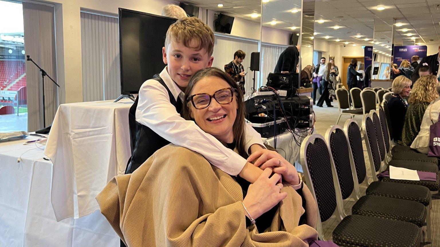 A young boy and a woman in her 30s together