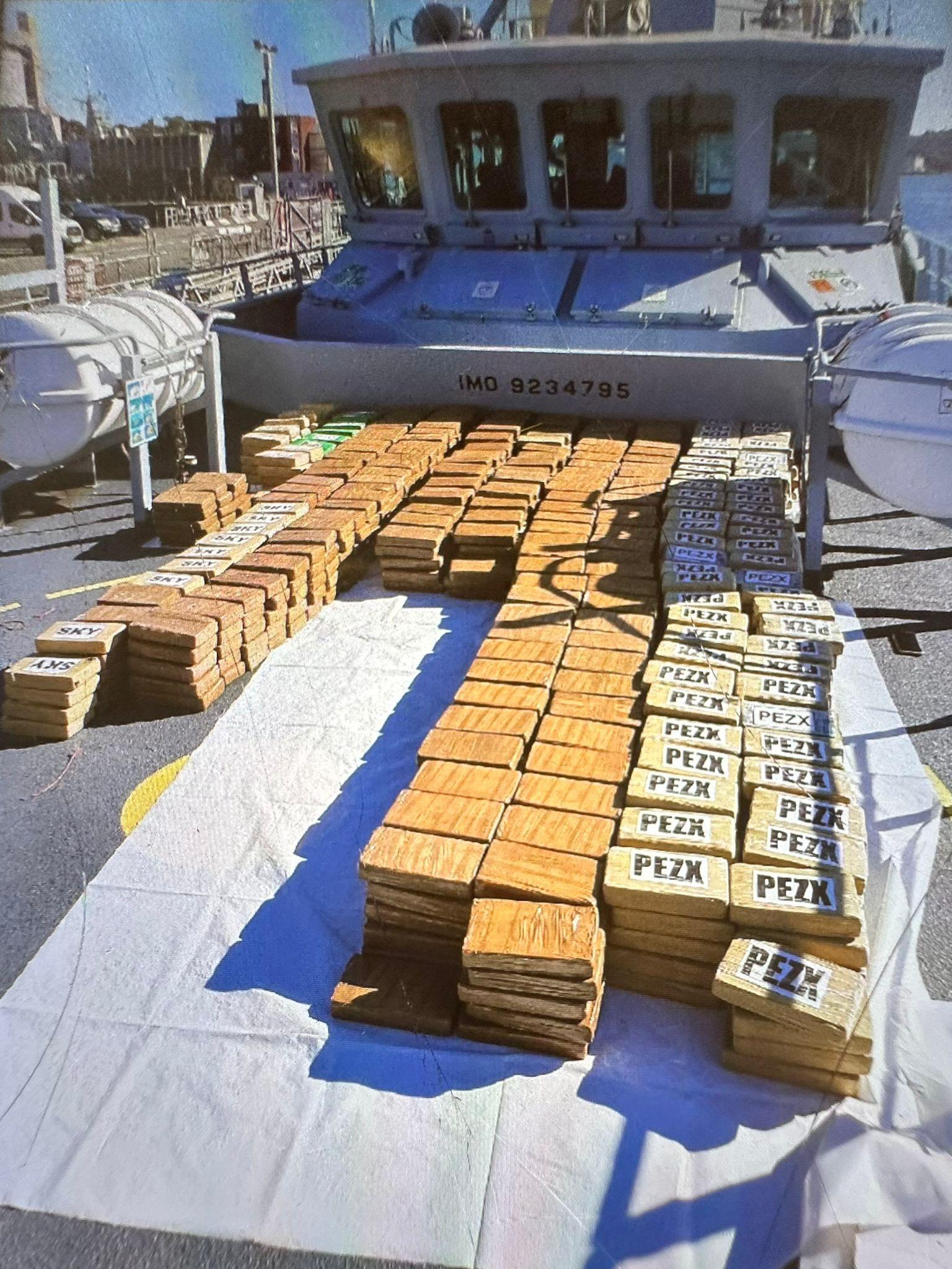 Dozens of packages laid out on the deck of a fishing boat