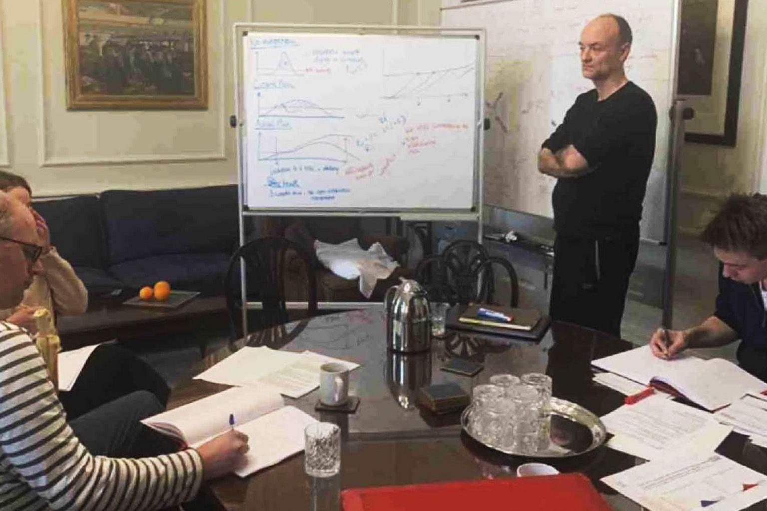Dominic Cummings standing by a whiteboard in the prime minister's office in Downing Street on Saturday 14 March 2020. To his left is the data scientist Ben Warner. Also in the room, according to Cummings, were Boris Johnson, special adviser Chloe Watson, director of communications Lee Cain, Faculty AI CEO Marc Warner, principle private secretary Imran Shafi, and deputy principal private secretary Stuart Glassborow.