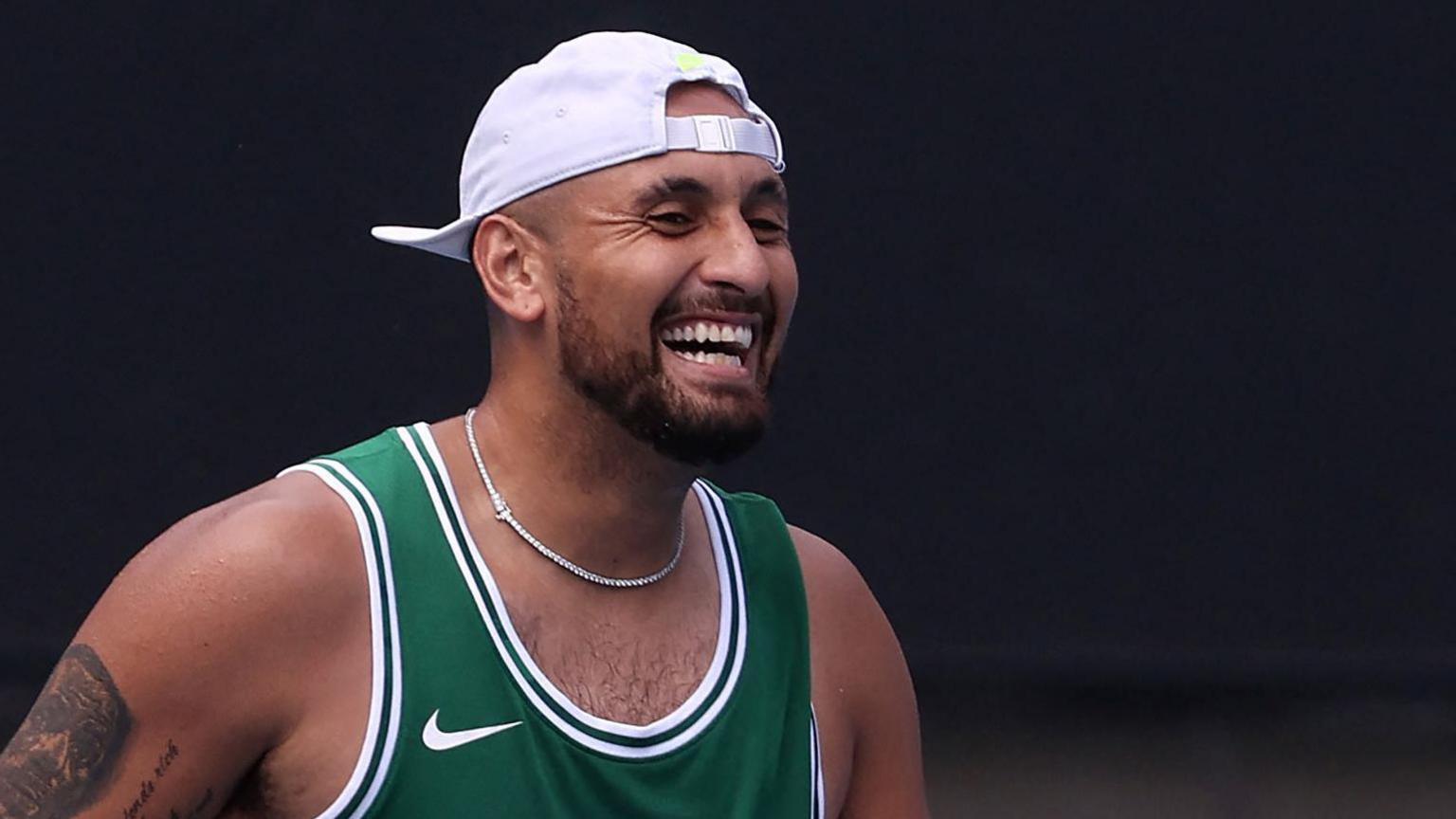 Nick Kyrgios laughs during practice at the Australian Open