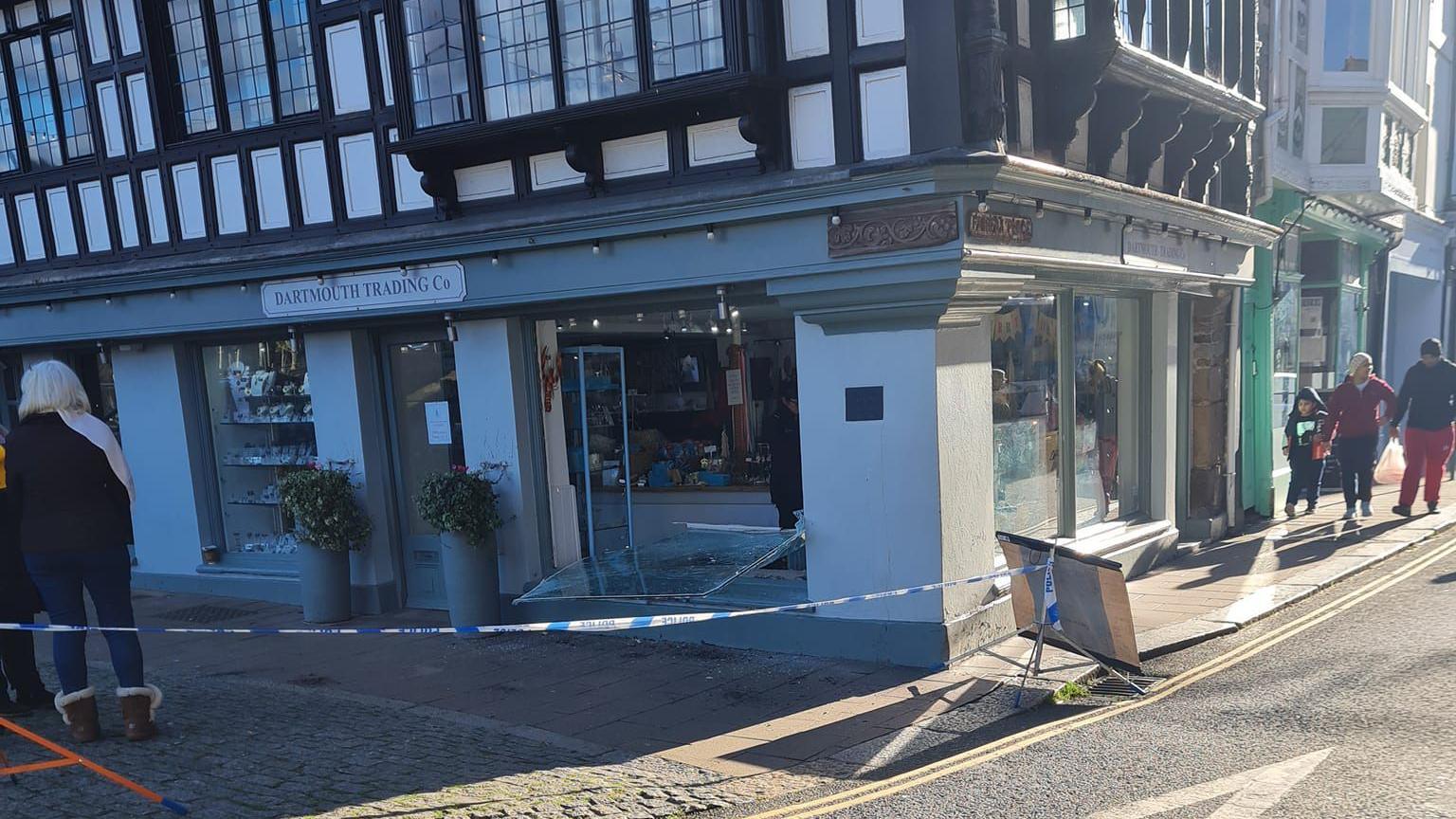 Police tape around a damaged shopfront in Dartmouth