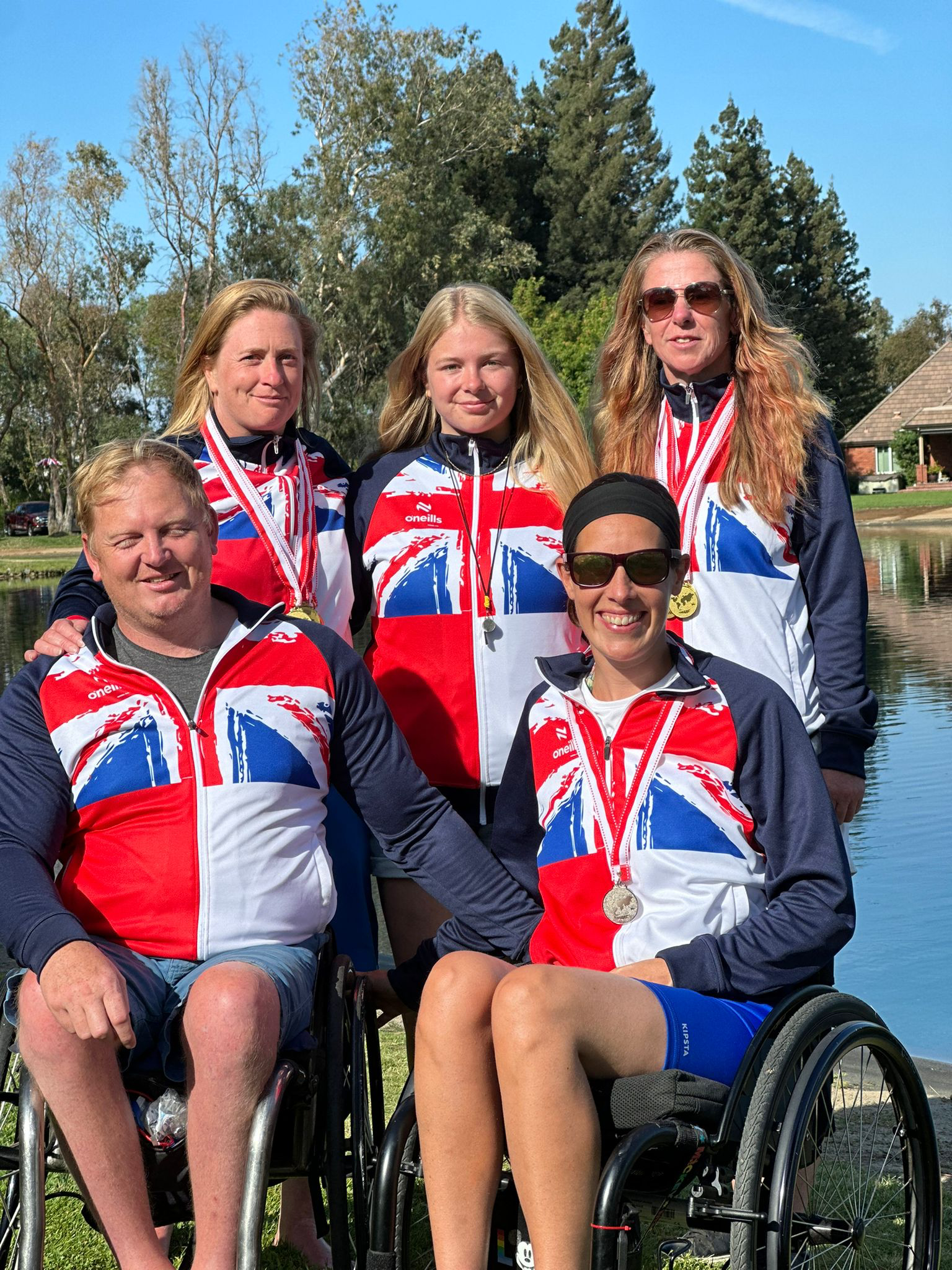 Williams stands behind two team mates in a wheelchair at World Championship Water Skiing event in California.