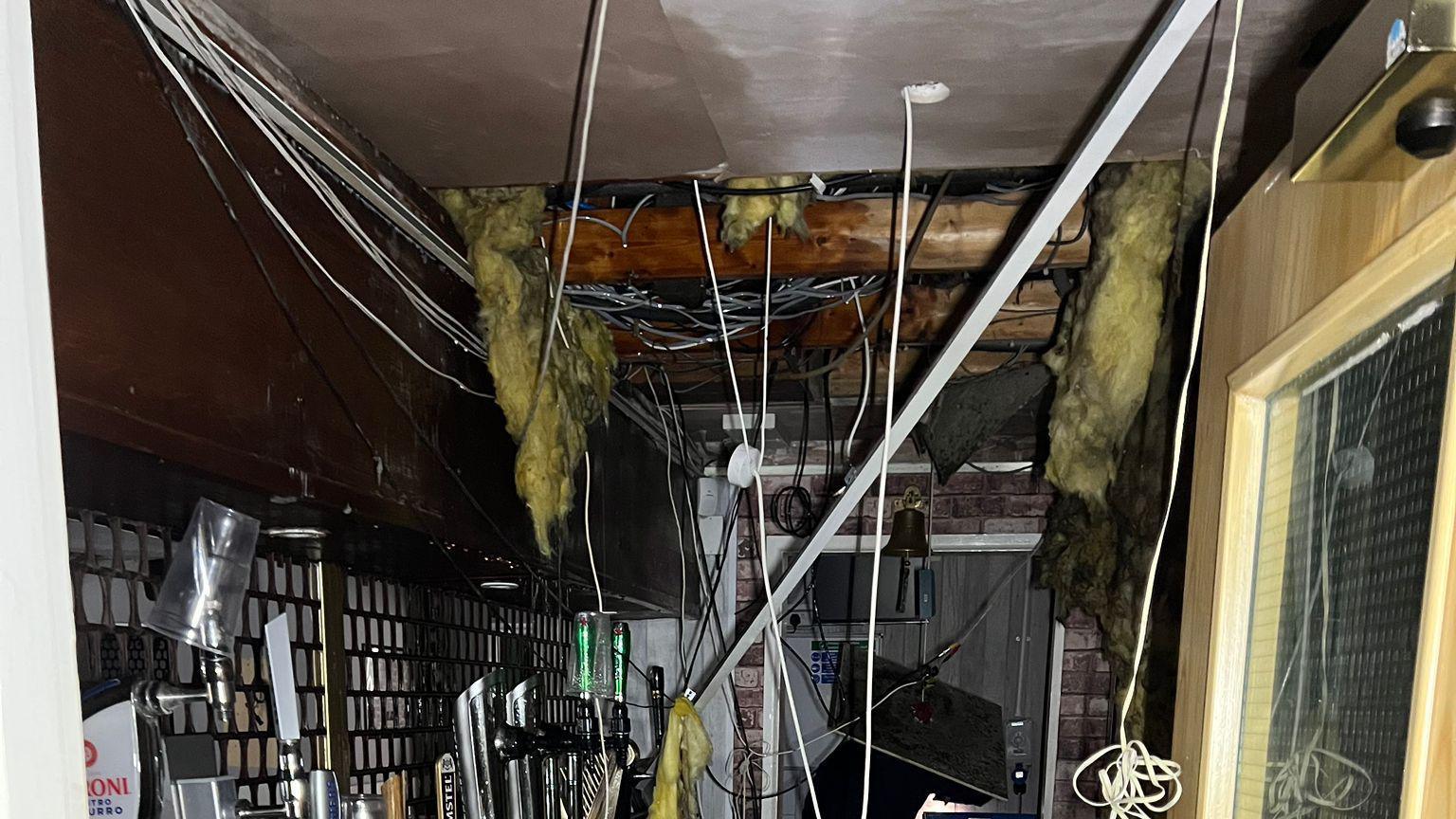 Ceiling panels have come down in the drinks bar of a community centre, wires are hanging out