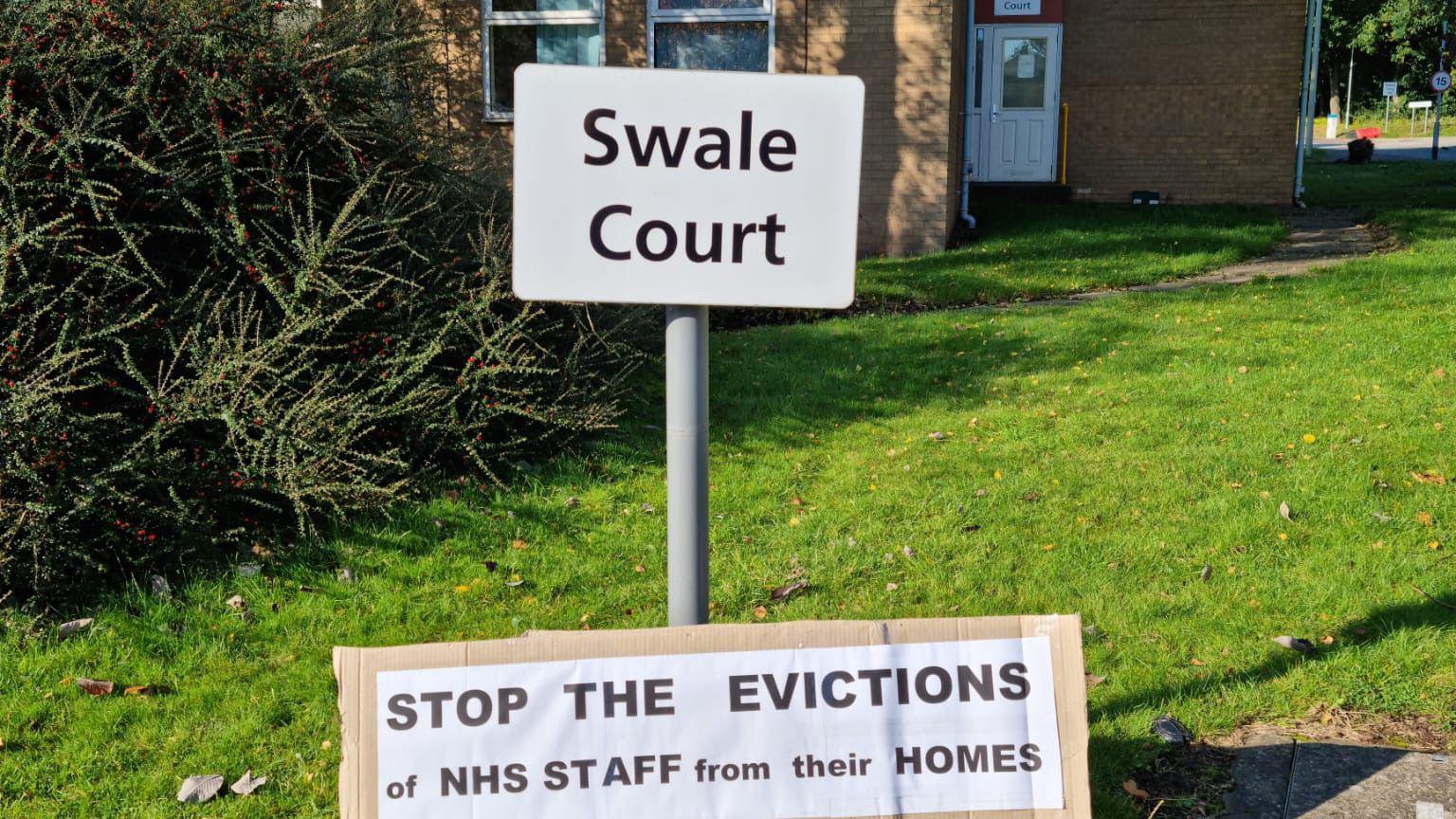 A block of flats with a sign outside saying 'Swale Court'