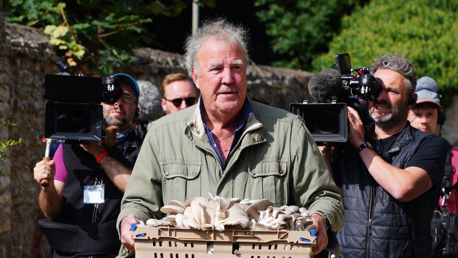 Jeremy Clarkson carrying mushrooms at the opening of his new pub, The Farmer's Dog, in Asthall, near Burford in Oxfordshire.