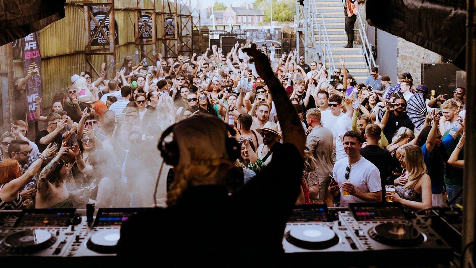 A DJ is silhouetted in front of crowds at Motion in Bristol