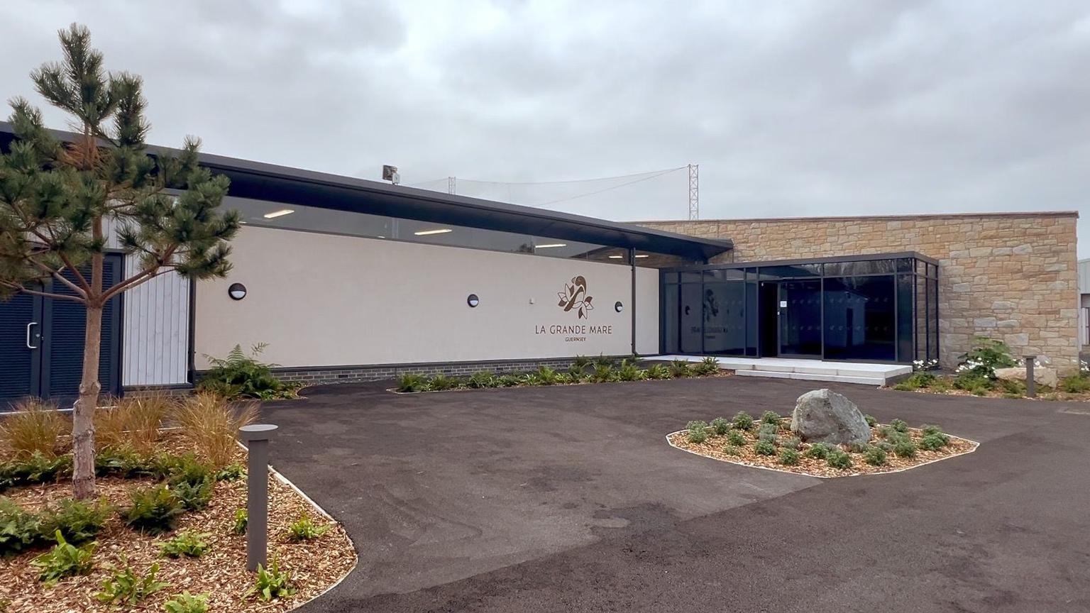The Golf Performance Centre facade is a mix of light brown stone and a smooth white exterior.