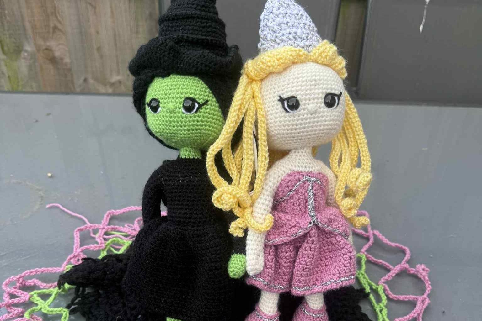 A view of a post box topper made up of Glinda and Elphaba, with each figure roughly "one foot" tall.