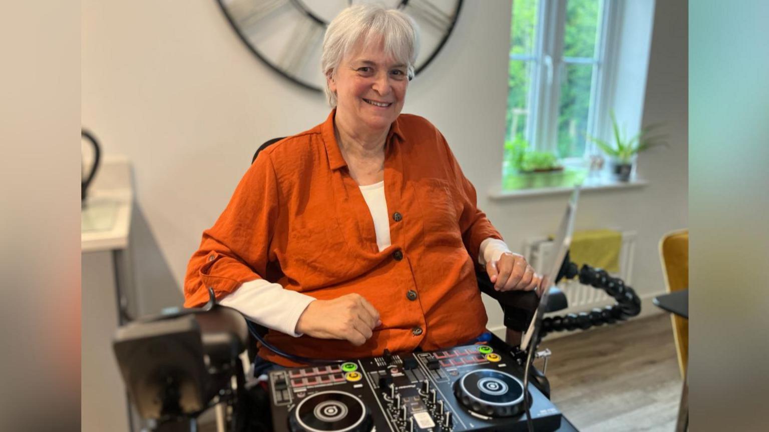 Sue, pictured with DJ decks on her lap