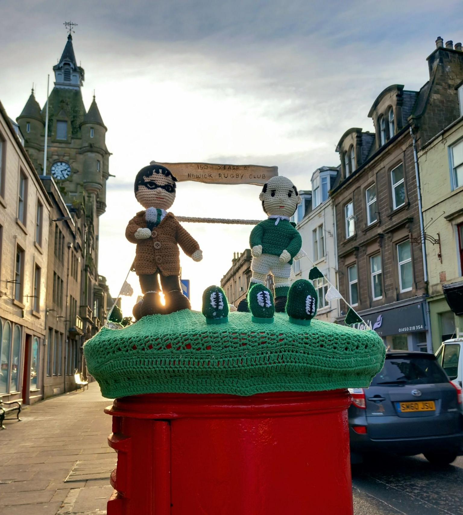 Knitted characters on a post box