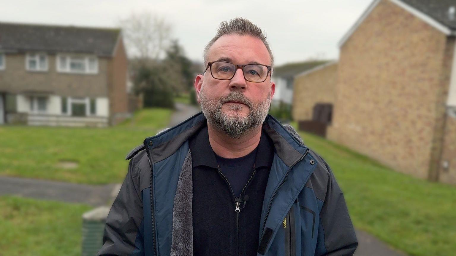 Church minister Neil Durling standing in front of a row of houses in Tonbridge