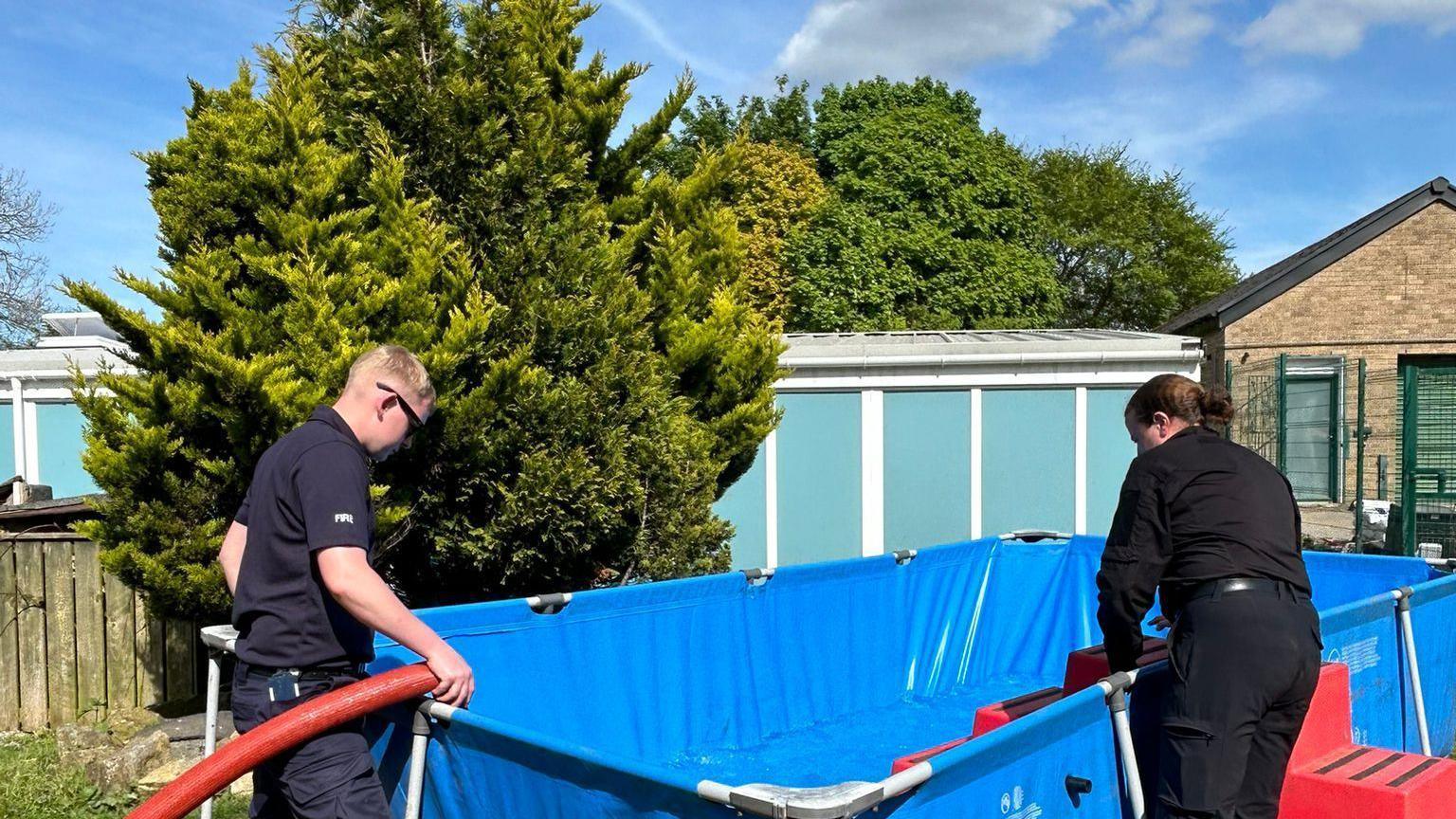 Fire crews filling up paddling pool