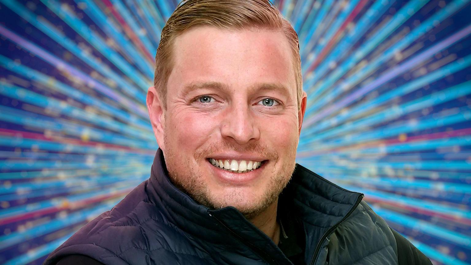 Thomas Skinner, wearing a black bodywarmer. He has short blonde hair.