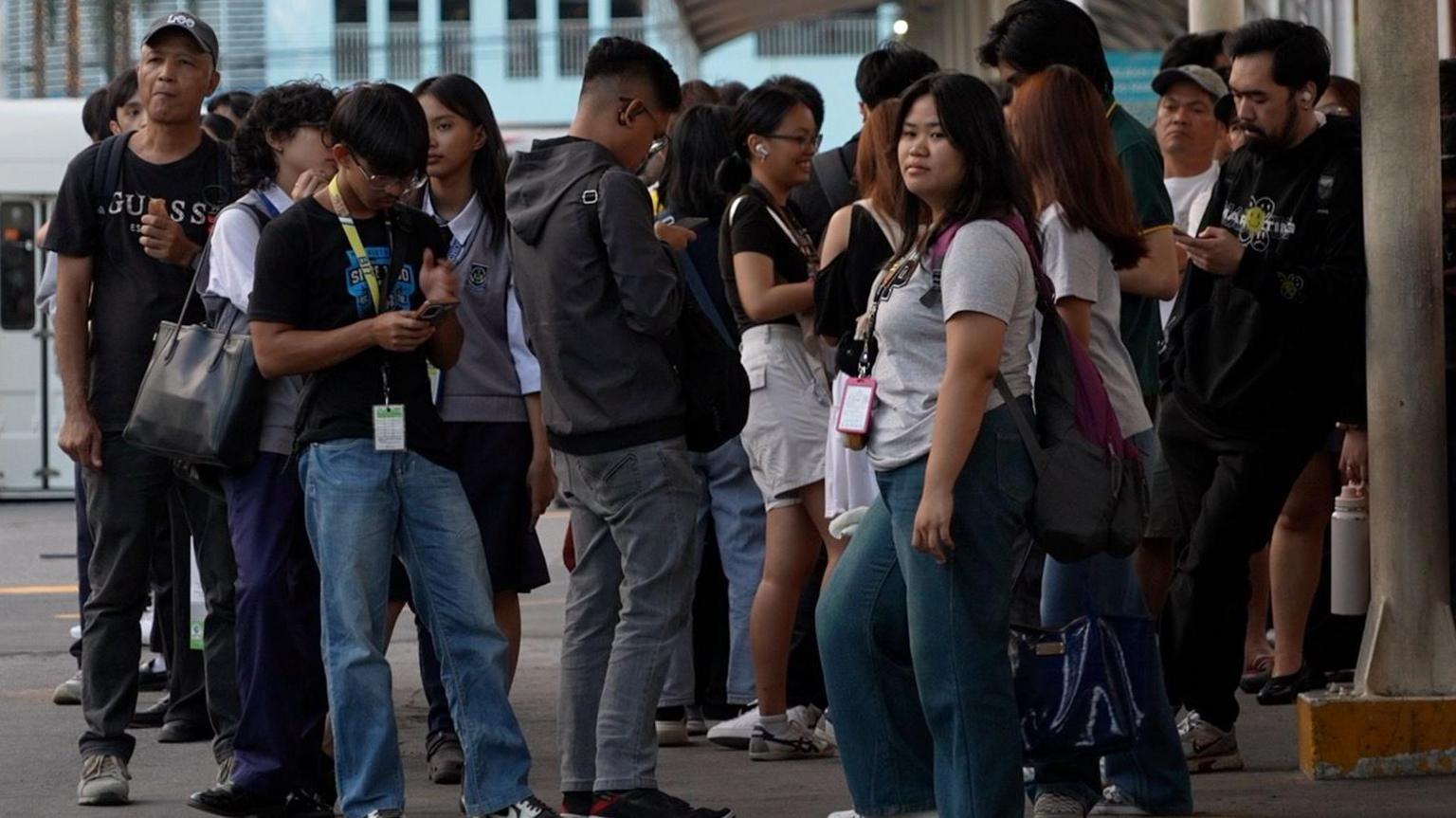 Call centre workers waiting for the bus after their shift