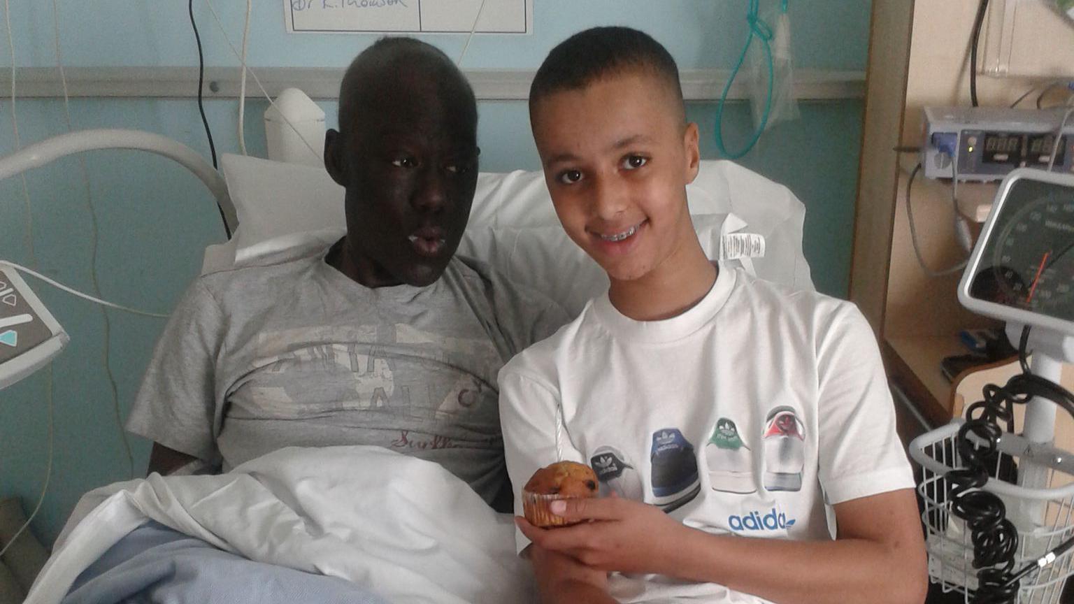 Joshua and his dad both sitting in a hospital bed