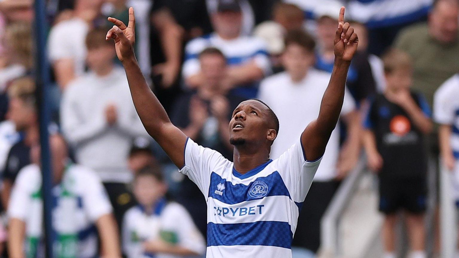 QPR's Richard Kone holds both arms in the air in celebration of scoring