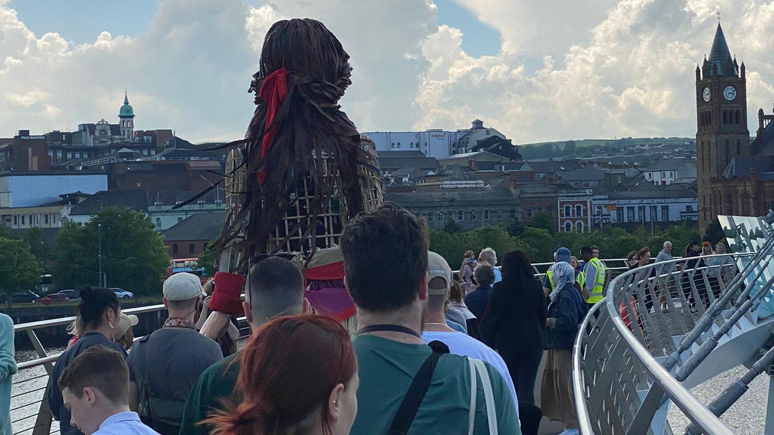 Little Amal puppet crossing the city's Peace Bridge