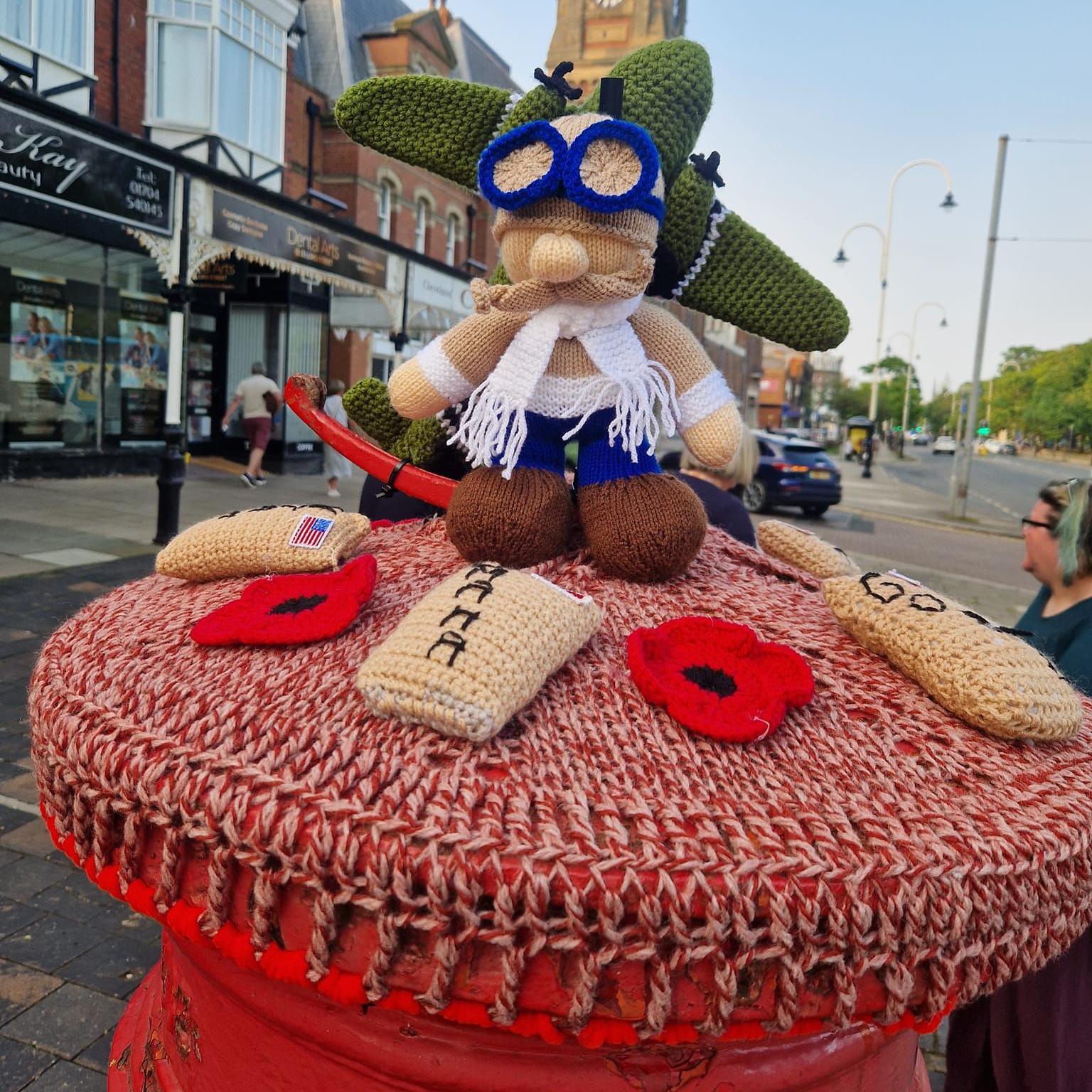 A crochet model of a pilot and a Lancaster bomber