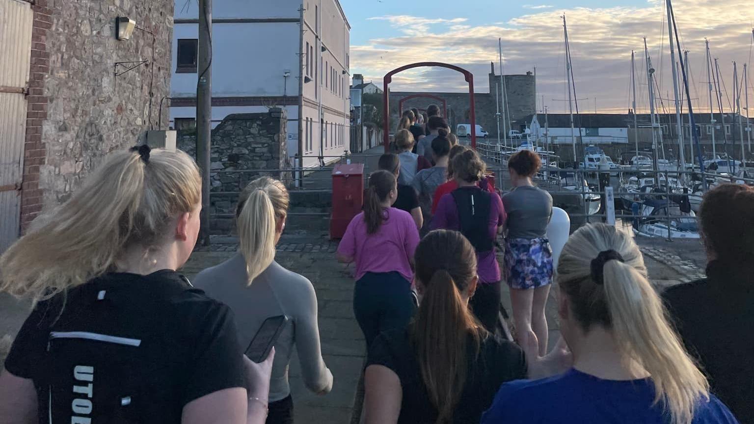 Picture of the back of a group of female runners in Caernarfon 