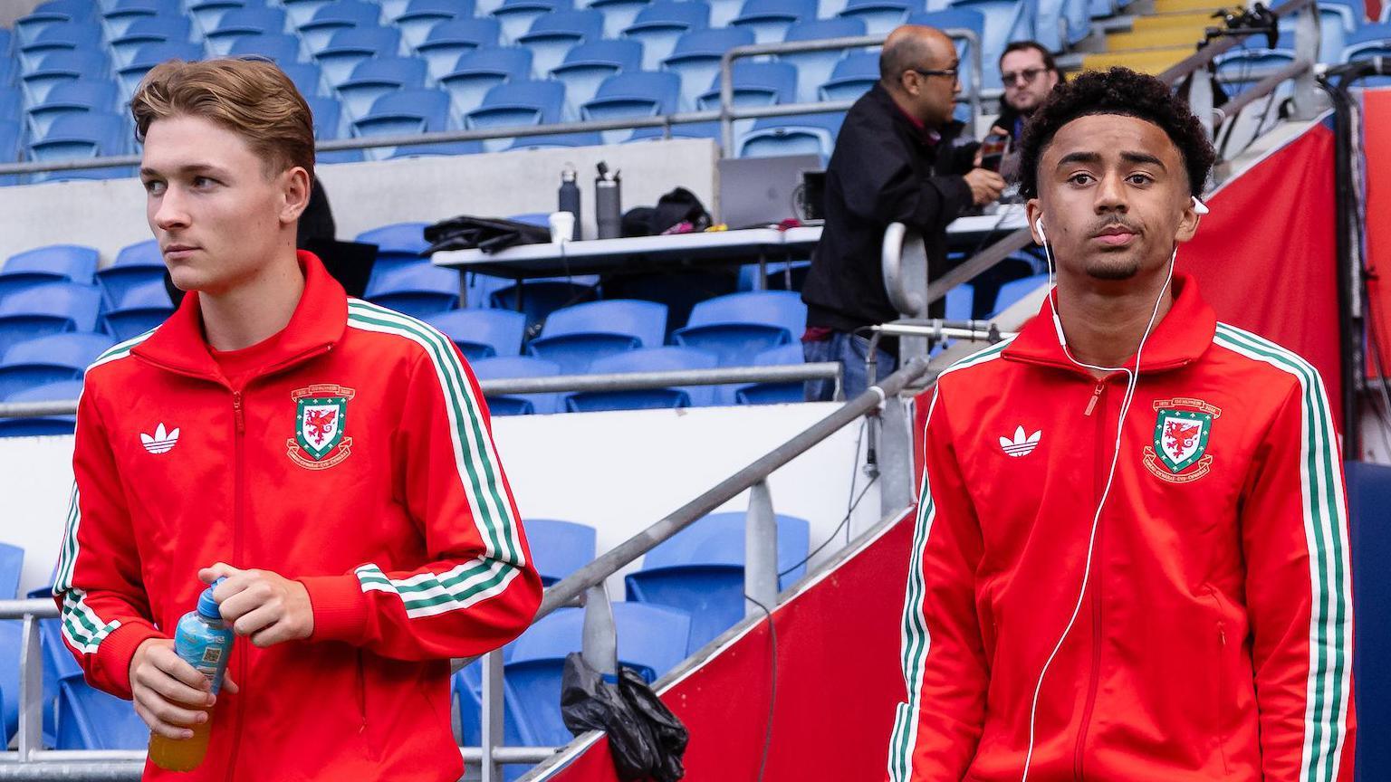 Oliver Bostock (left) and Jayden Lienou walk out pre-match at Cardiff City Stadium