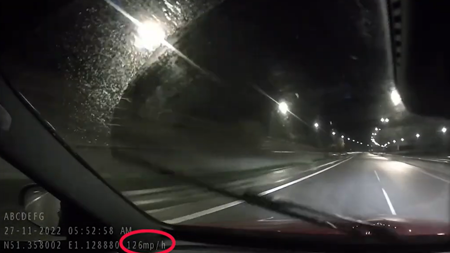 A screenshot of dashcam footage which has a red cirlce around the speed, which says 126mph.