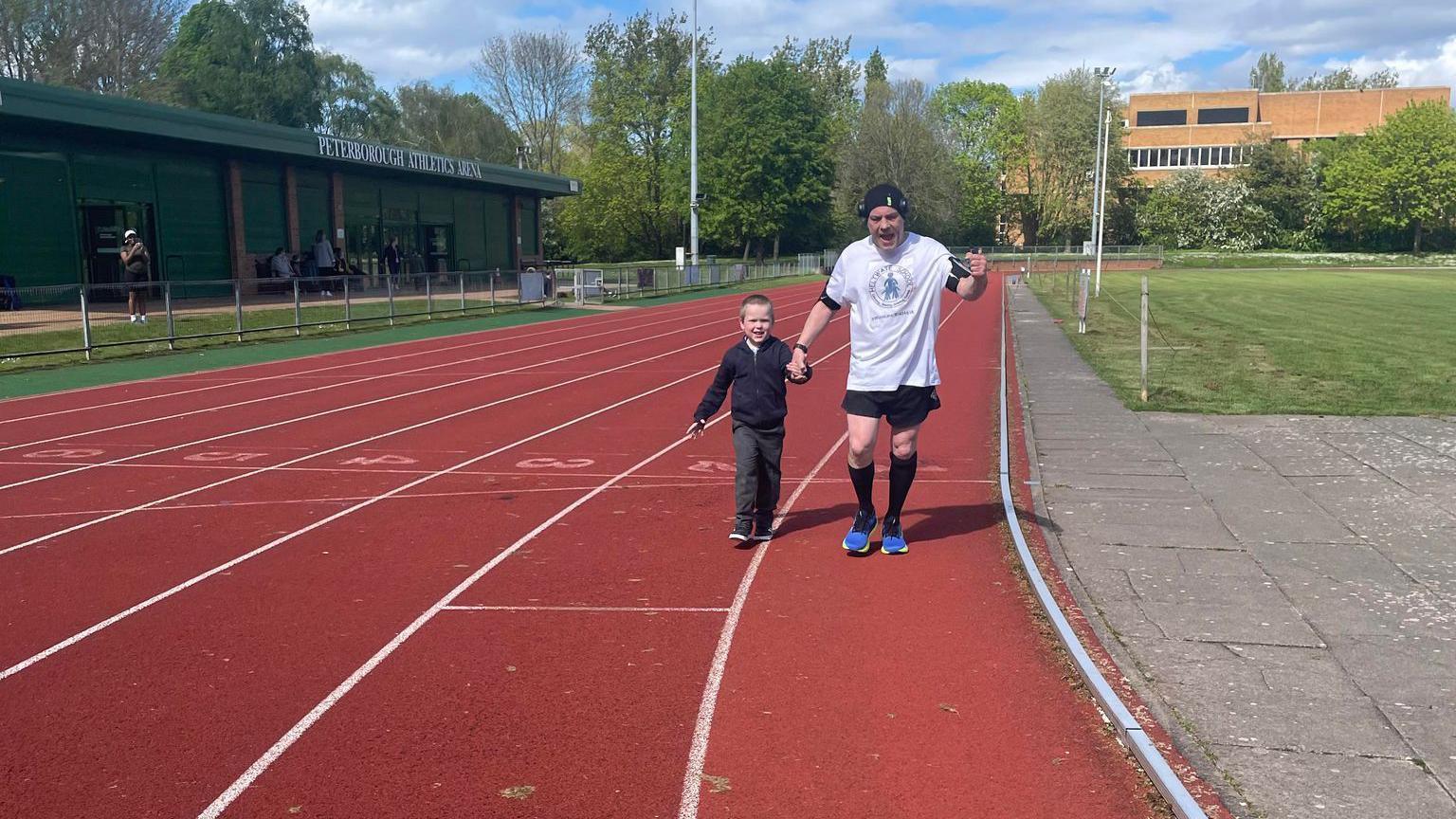 Jason and and running on an athletics track 