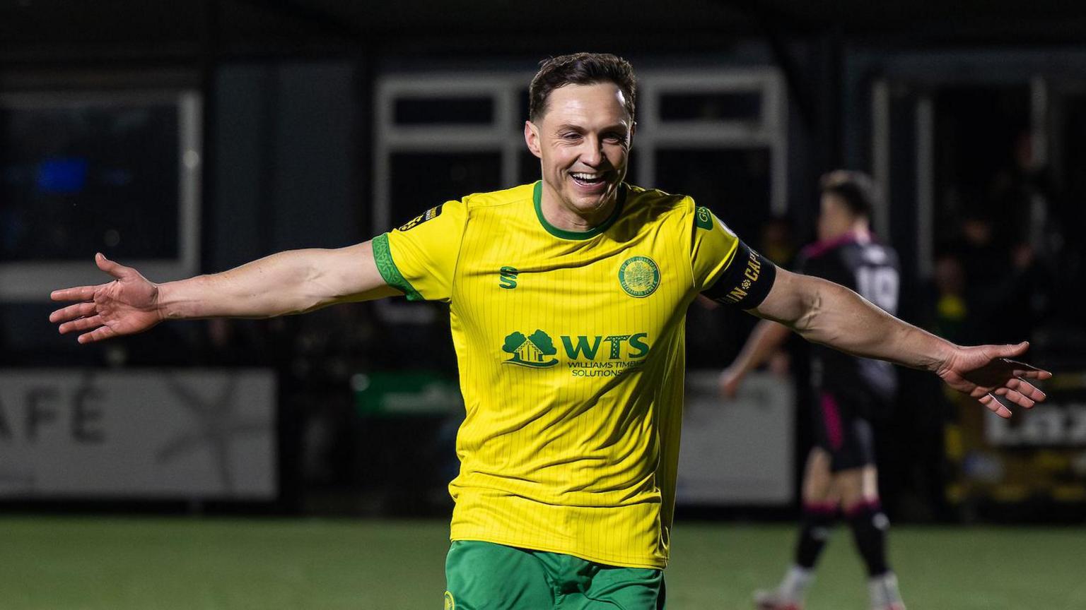 Danny Gossett celebrates his goal to make it 3-0 during the JD Cymru Premier between Caernarfon Town and Colwyn Bay