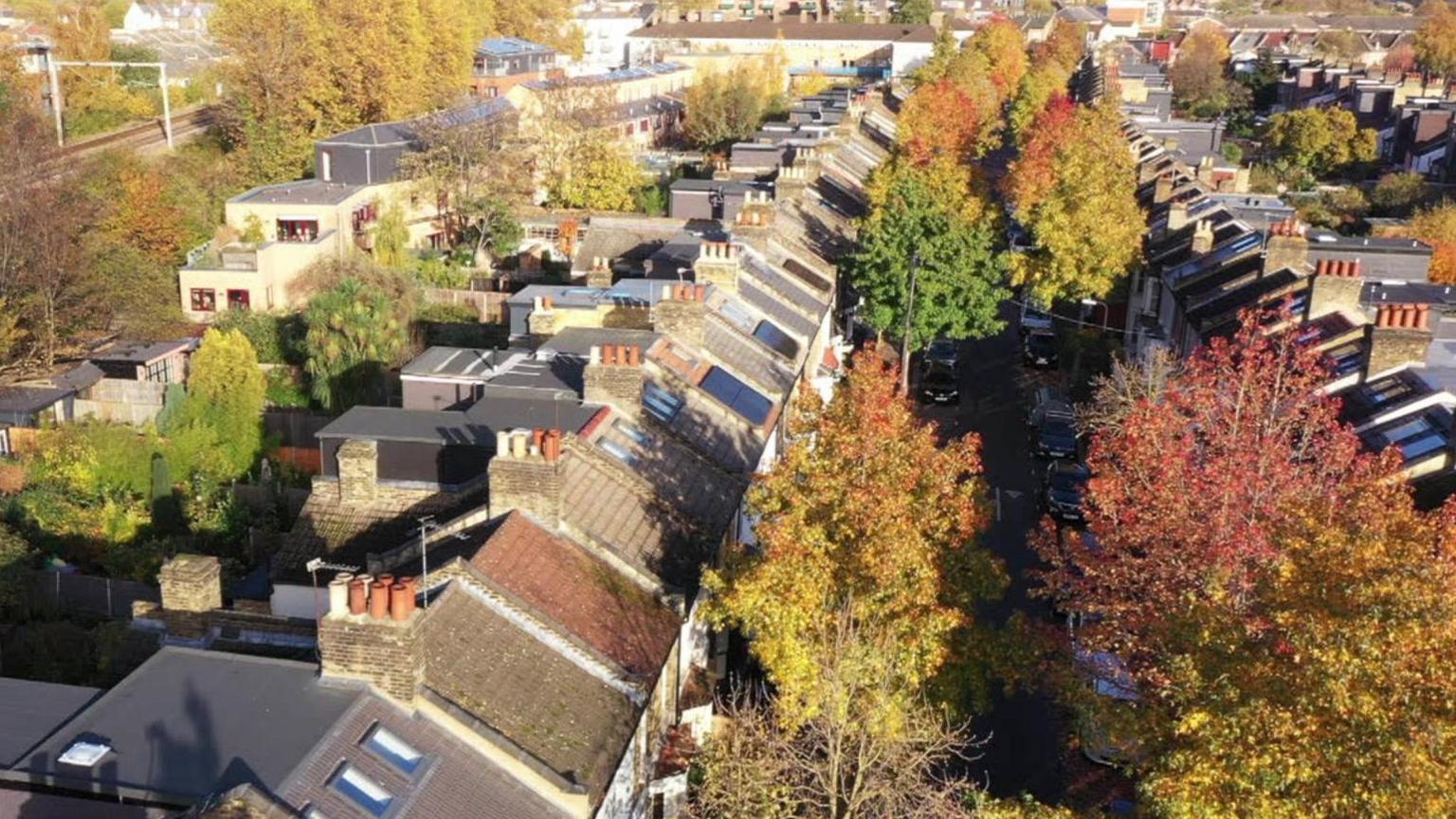 Aerial view of a street with solar panels on roofs 