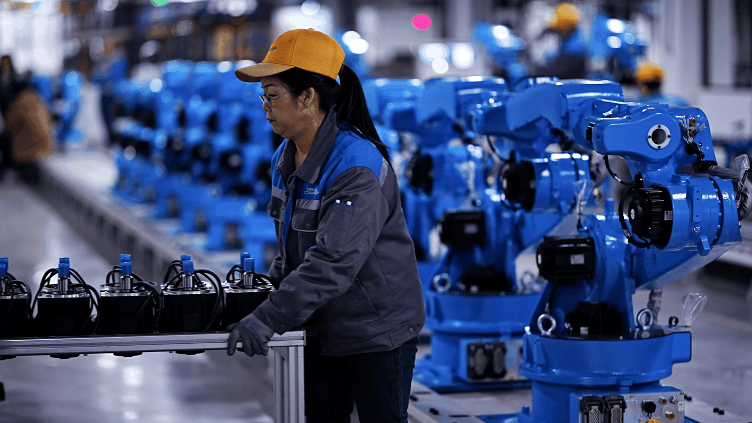 A woman operating a machine at a factory in Chengdu.