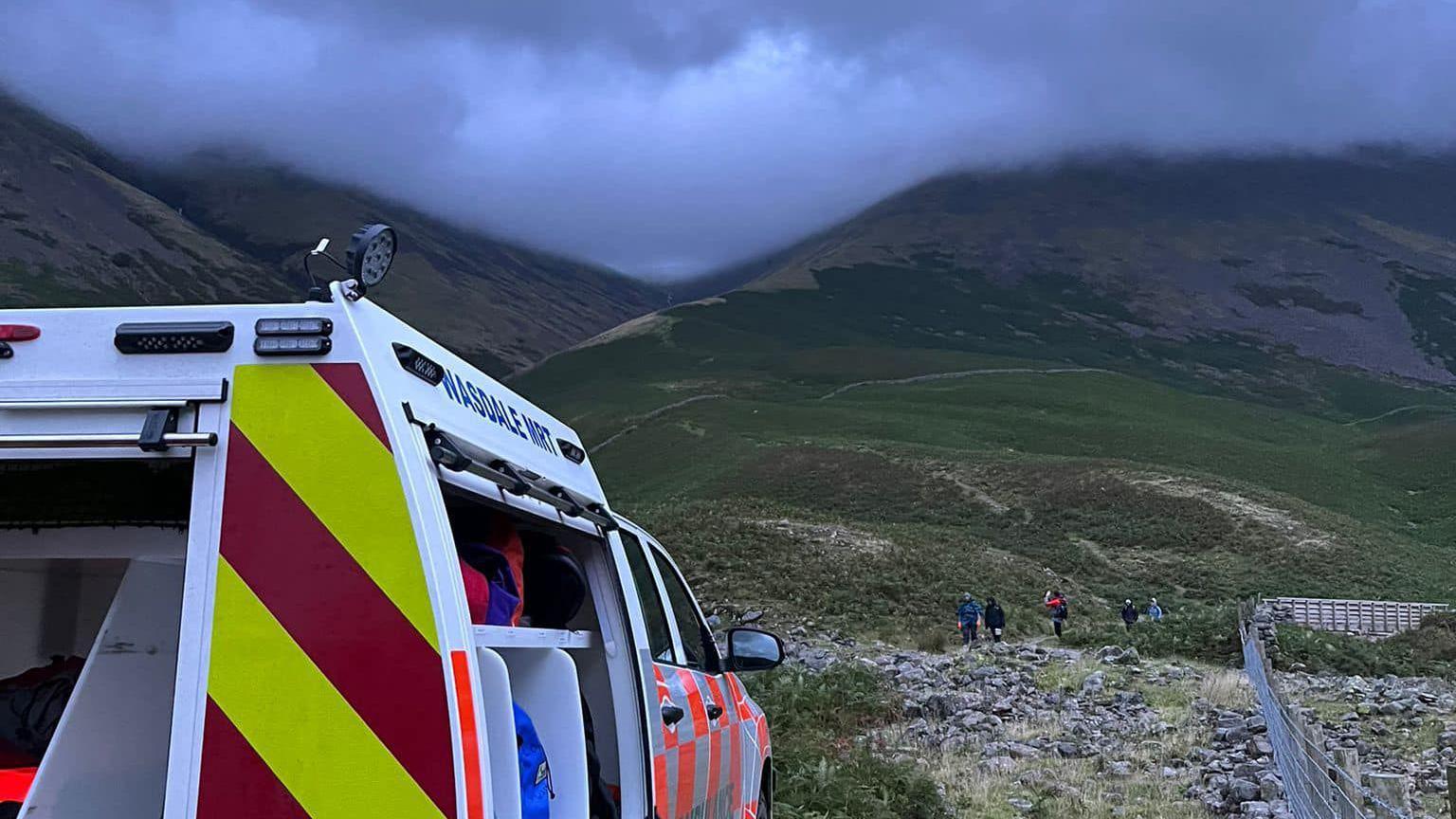 Wasdale Mountain Rescue Team's vehicle below valley while rescue goes ahead