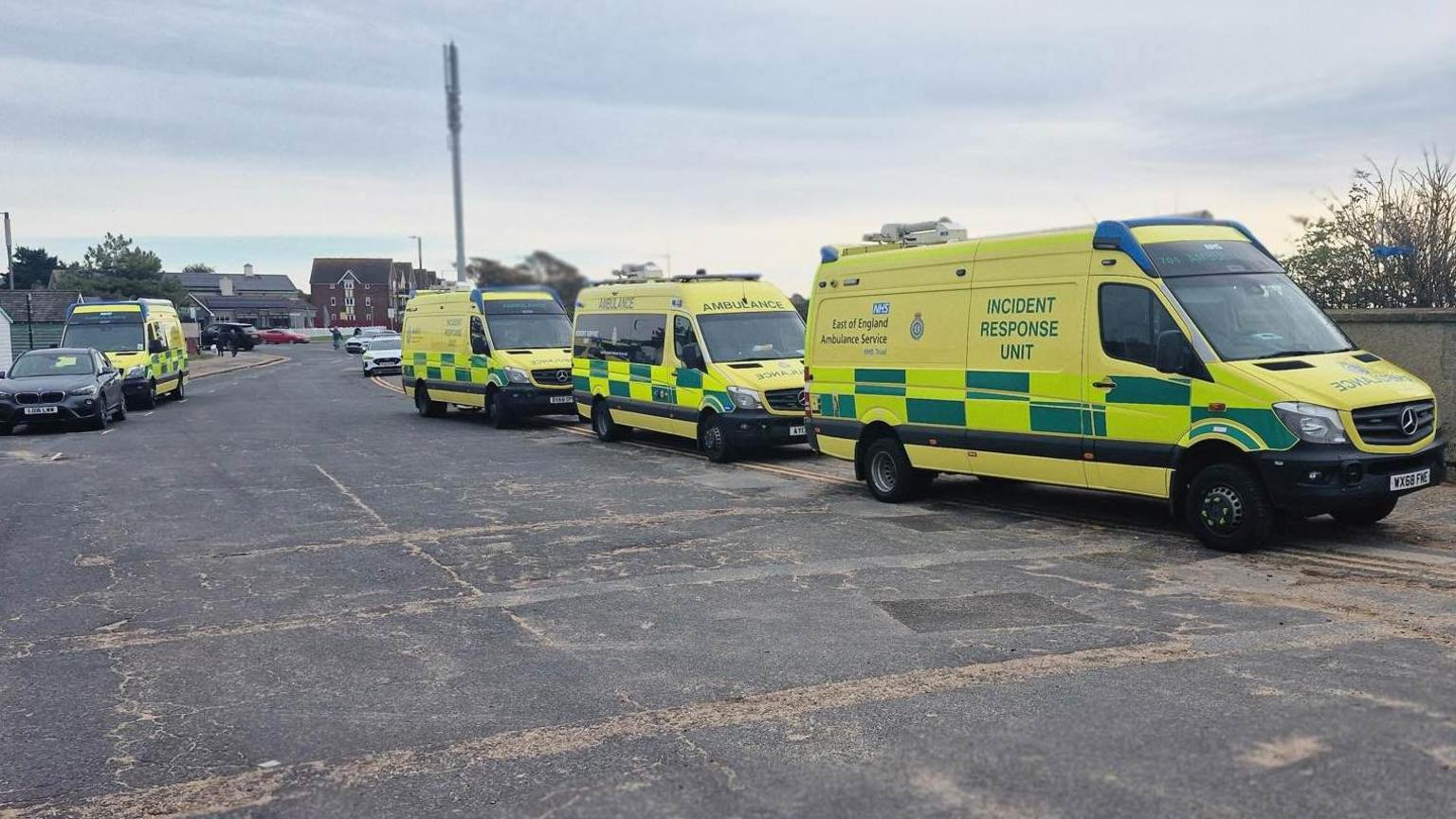 Four ambulances parked either side of a road