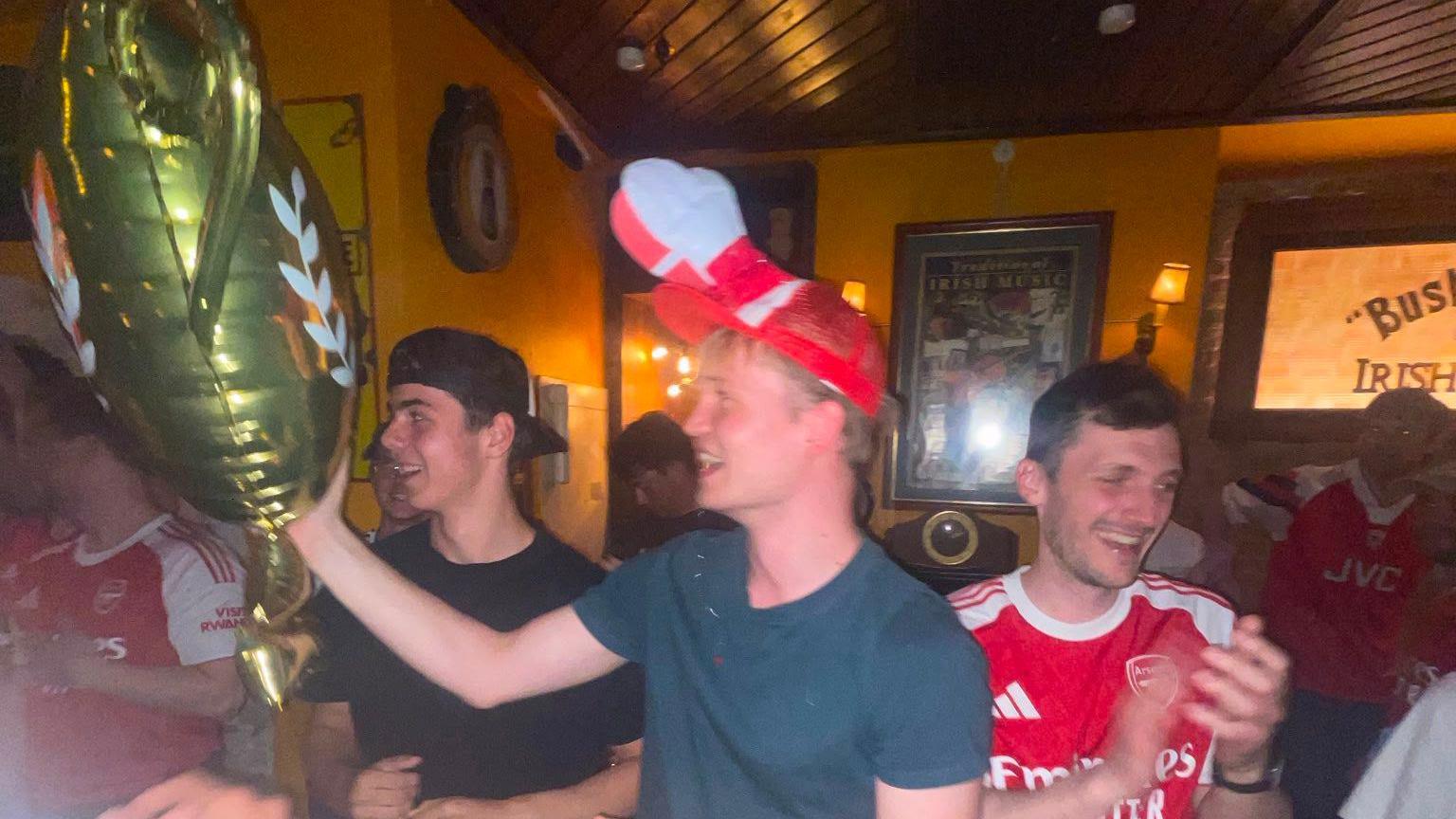 Erik Ibsen in a pub with a novelty cap and gold balloon
