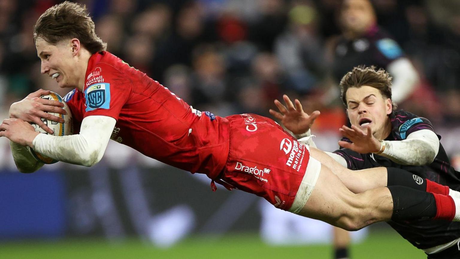 Ellis Mee dives to score a try for Scarlets against Ospreys in December 2024