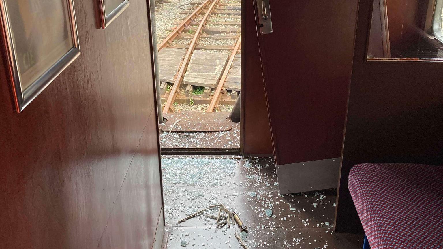 Smashed glass on the floor of the railway carriage