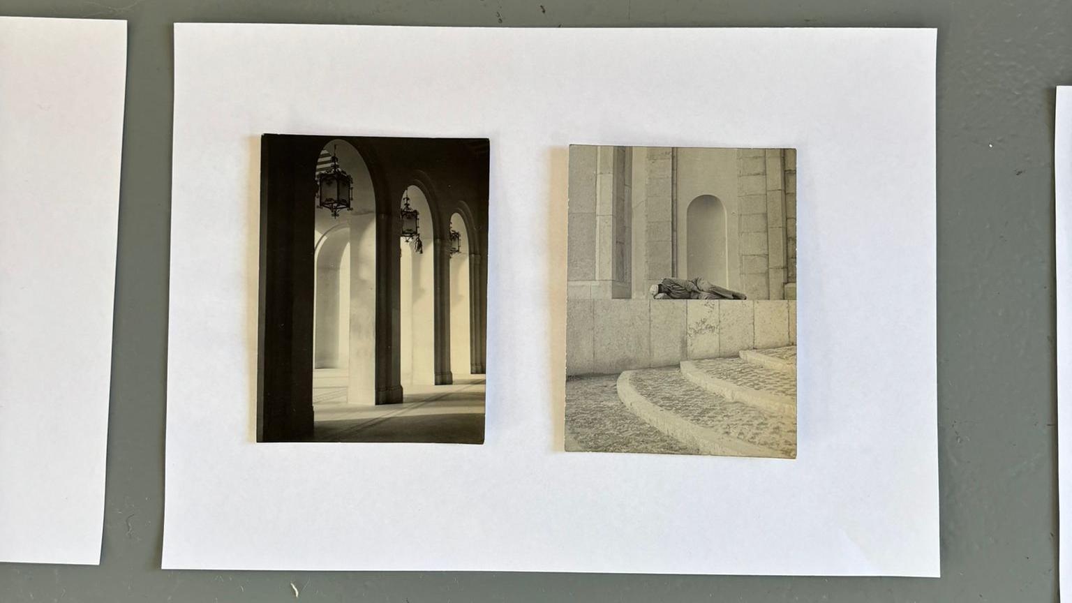 Two black and white photographs side by side. The one on the left depicts arches and on the right a man is lying on a white wall in the foetal position.