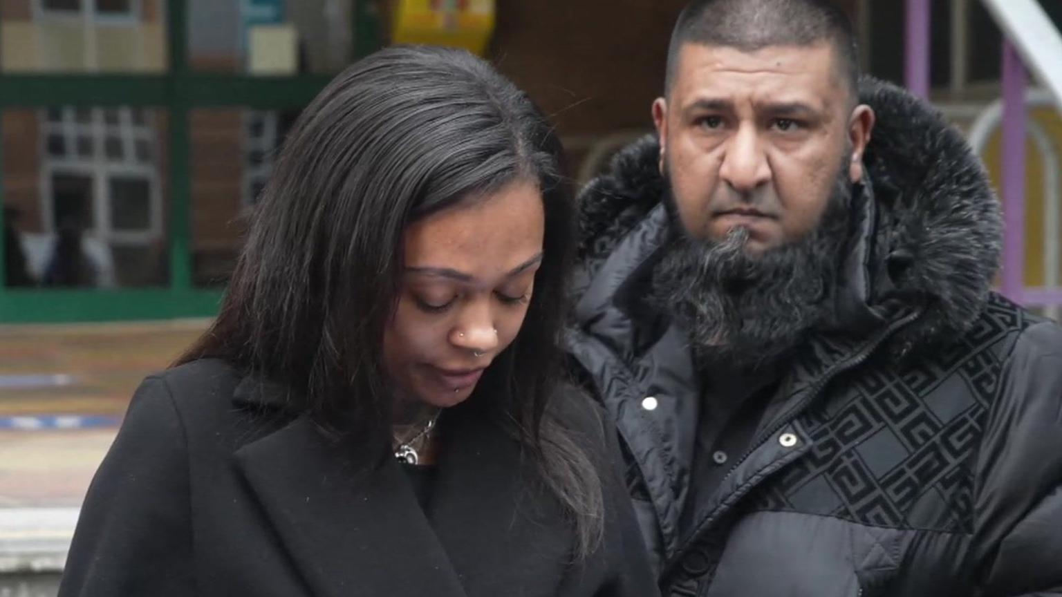 Stephanie Williams and Asim Khan, both wearing black coats stand on the steps of Bournemouth Coroner's Court. Mrs Williams is looking down reading a statement