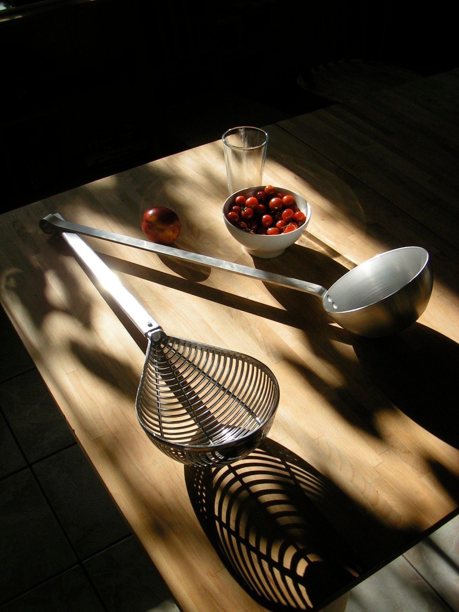 Still life of ladles on a wooden surface