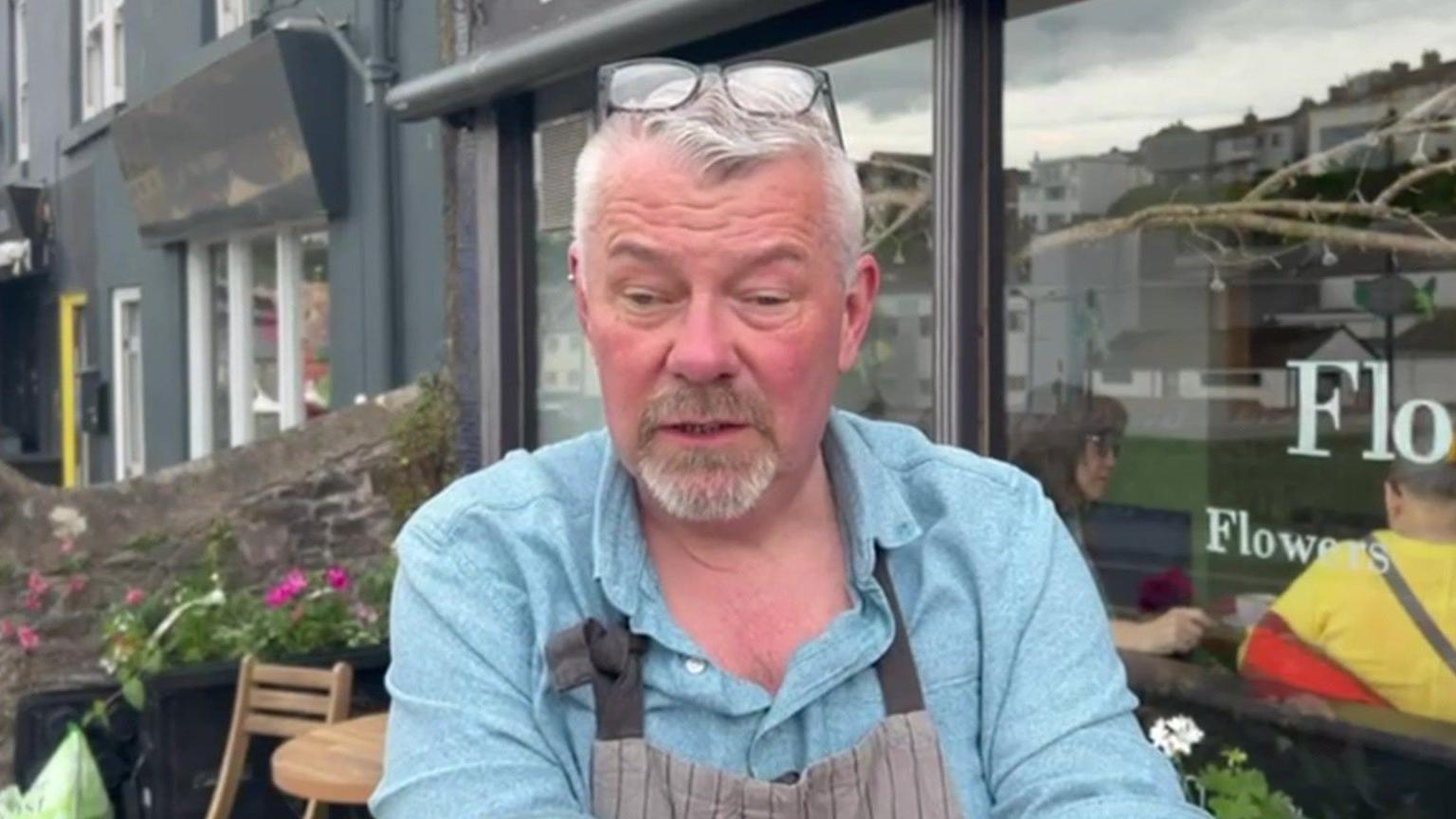 Simon Webb outside Flour Flower Cafe and Florist