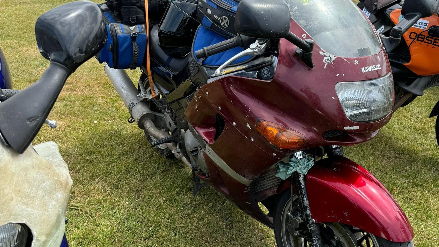 An old motorbike with luggage on