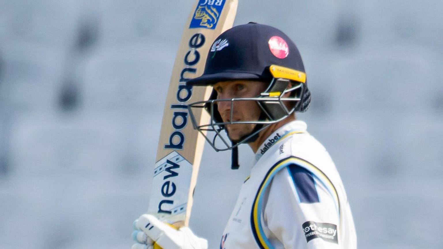 Joe Root raises his bat to the crowd after reaching 50 for Yorkshire against Warwickshire