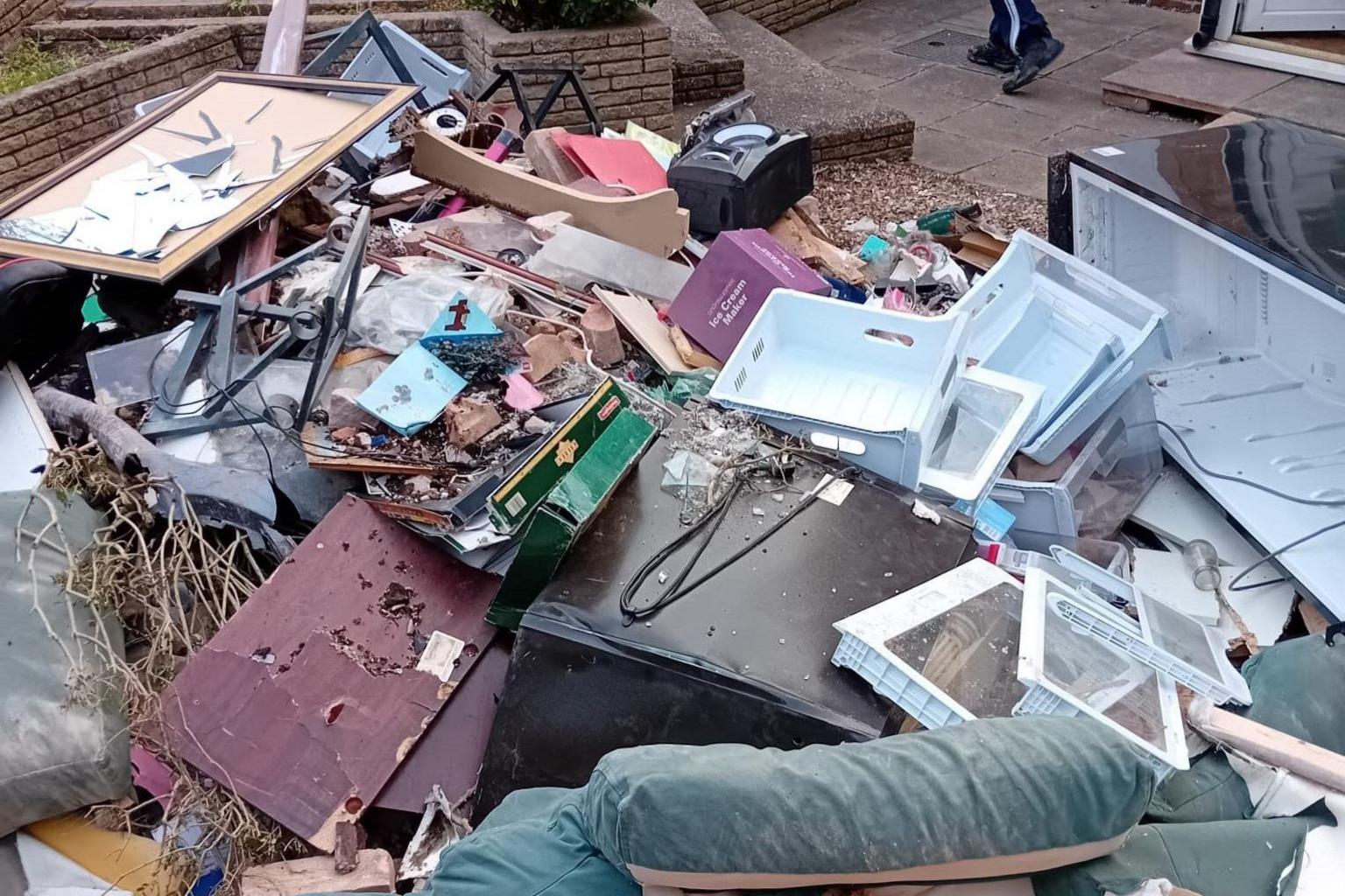 Another view of Mrs Richardson's garden with more stuff piled outside ready to be salvaged or thrown away.