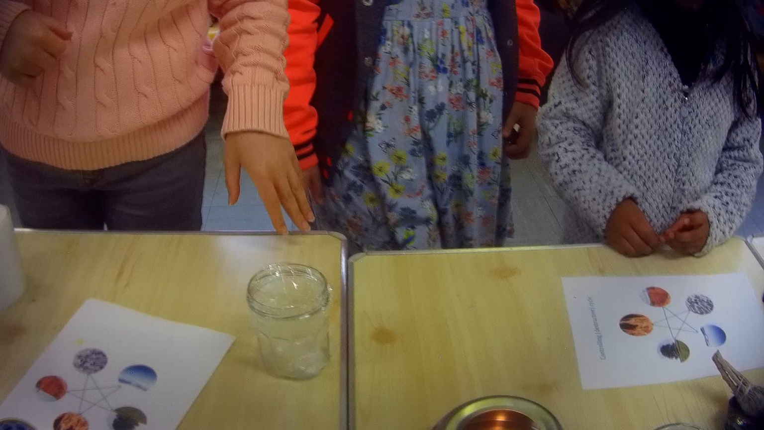 Children looking at a desk 