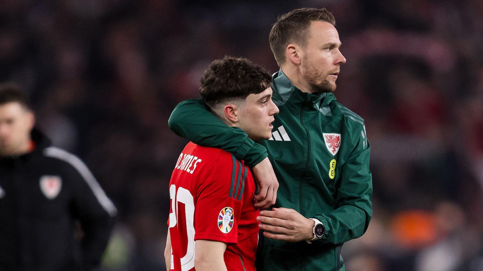 Chris Gunter consoles his former Wales team-mate Daniel James after his penalty miss proved decisive against Poland